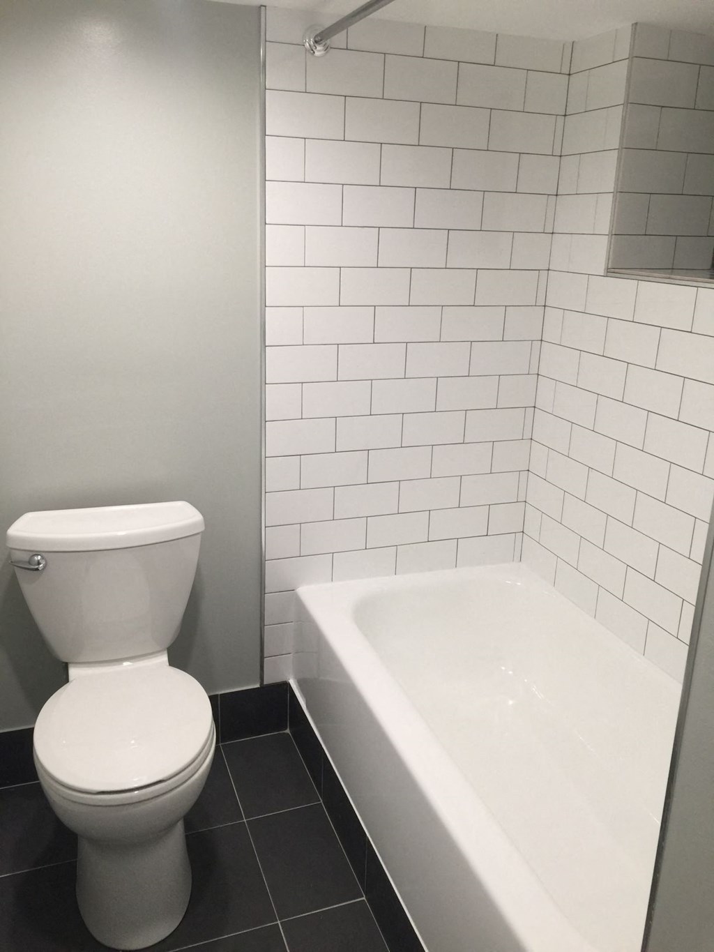 a bathroom with a toilet and a bath tub