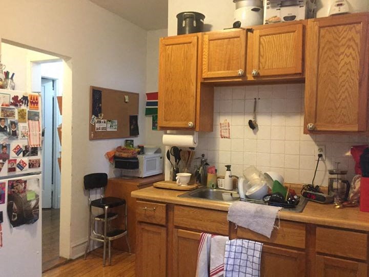 a kitchen with wooden cabinets and a sink and a refrigerator