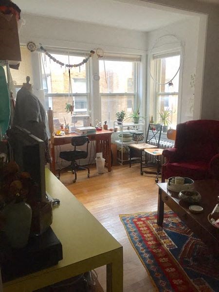 a living room with a large window and a table