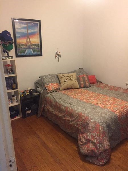 a bedroom with a bed with pillows on it