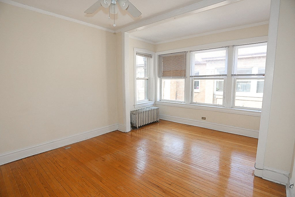 the living room of an empty house with wood floors