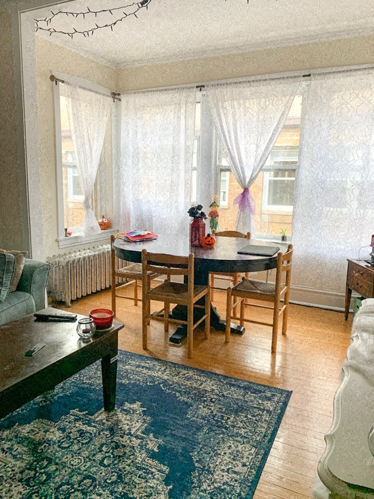 a living room and dining room with a table and chairs