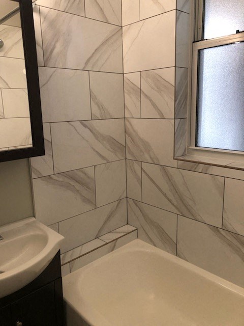 a bathroom with a bath tub and a sink