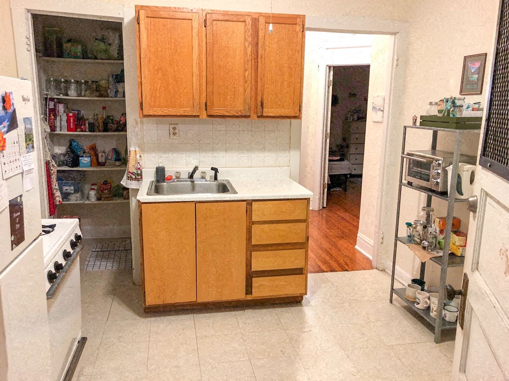 a kitchen with a sink and wooden cabinets