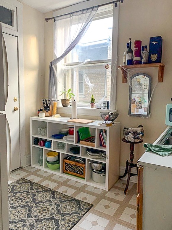 a small kitchen with a window and some shelves