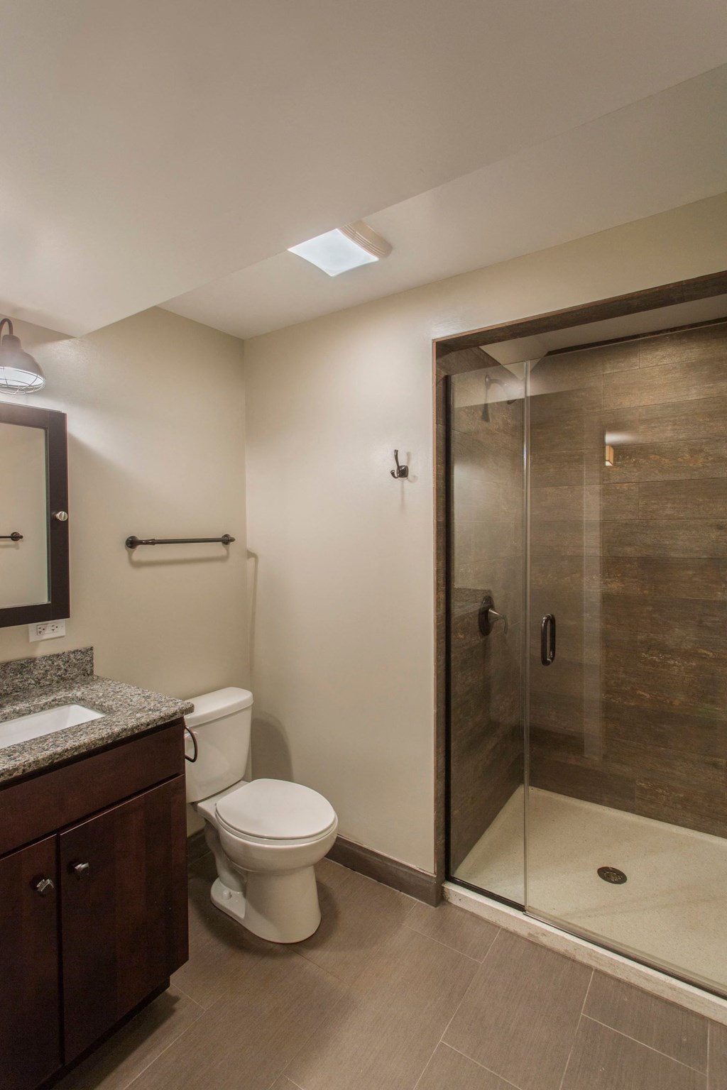 a small bathroom with a shower toilet and sink
