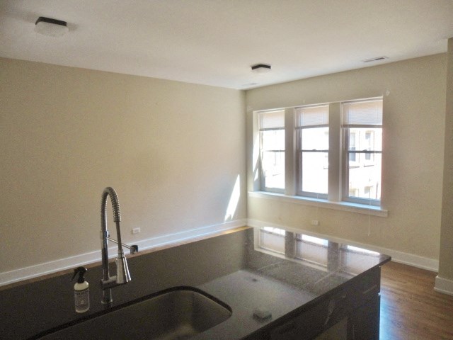 an empty kitchen with a sink and a window