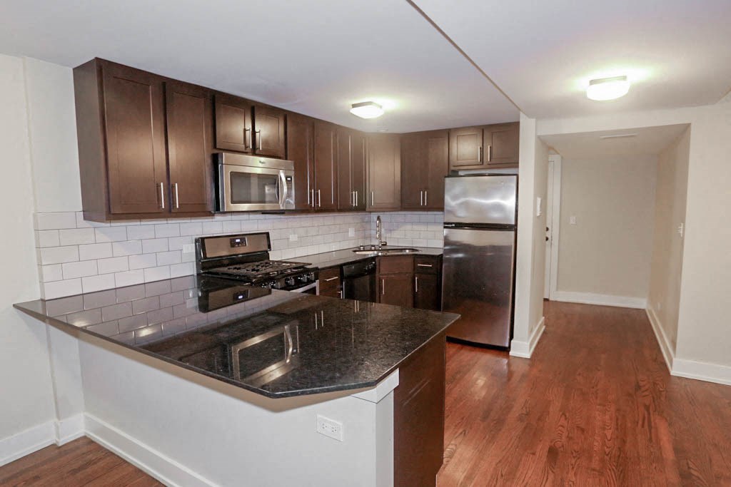 a kitchen with an island and stainless steel appliances