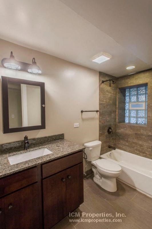 a bathroom with a toilet and a sink and a bath tub
