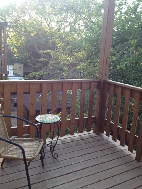 a deck with a chair and a table on it