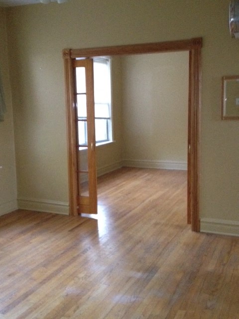 a living room with a wooden floor and an open door