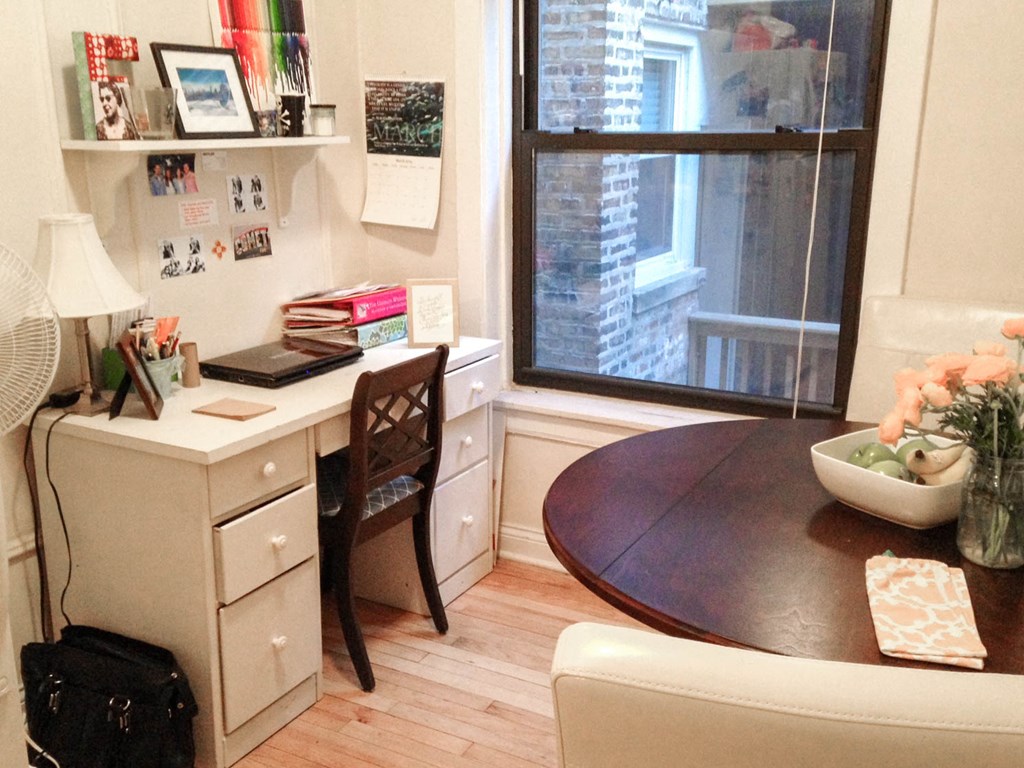 a small dining room with a table and a window