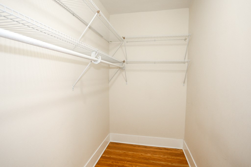 an empty room with white walls and a wood floor