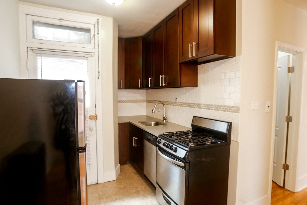 a kitchen with stainless steel appliances and wooden cabinets