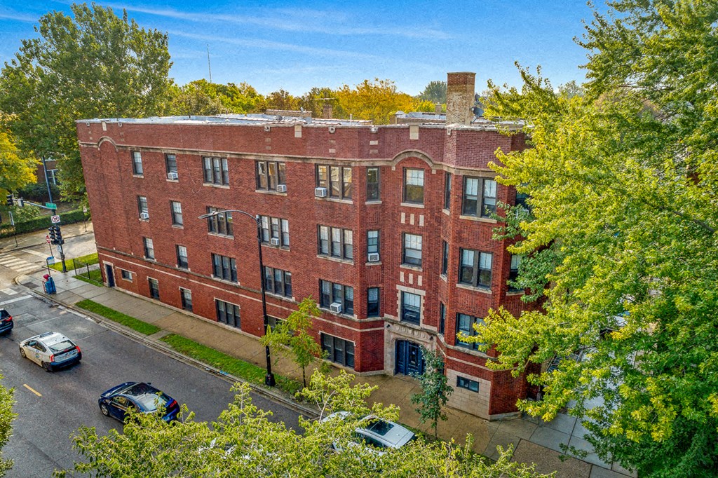a view of a red brick building from above with trees