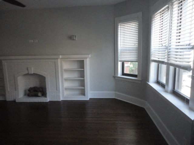 a living room with a fireplace and a window