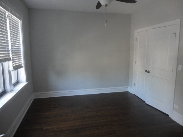 an empty room with wooden floors and a white door