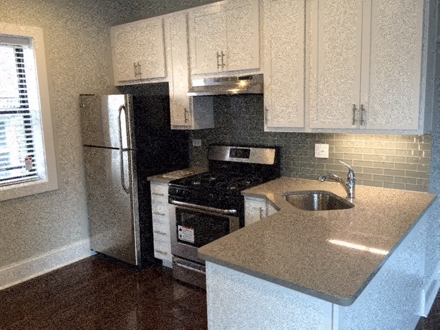 a kitchen with a sink and a refrigerator