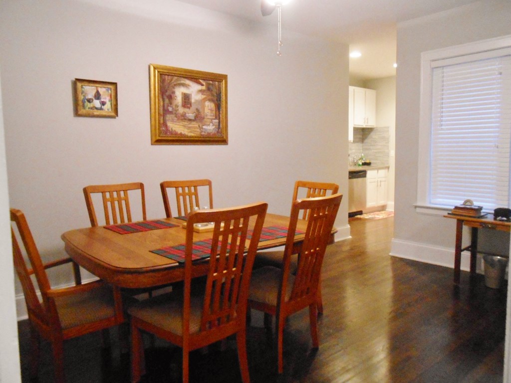 a dining room with a wooden table and chairs
