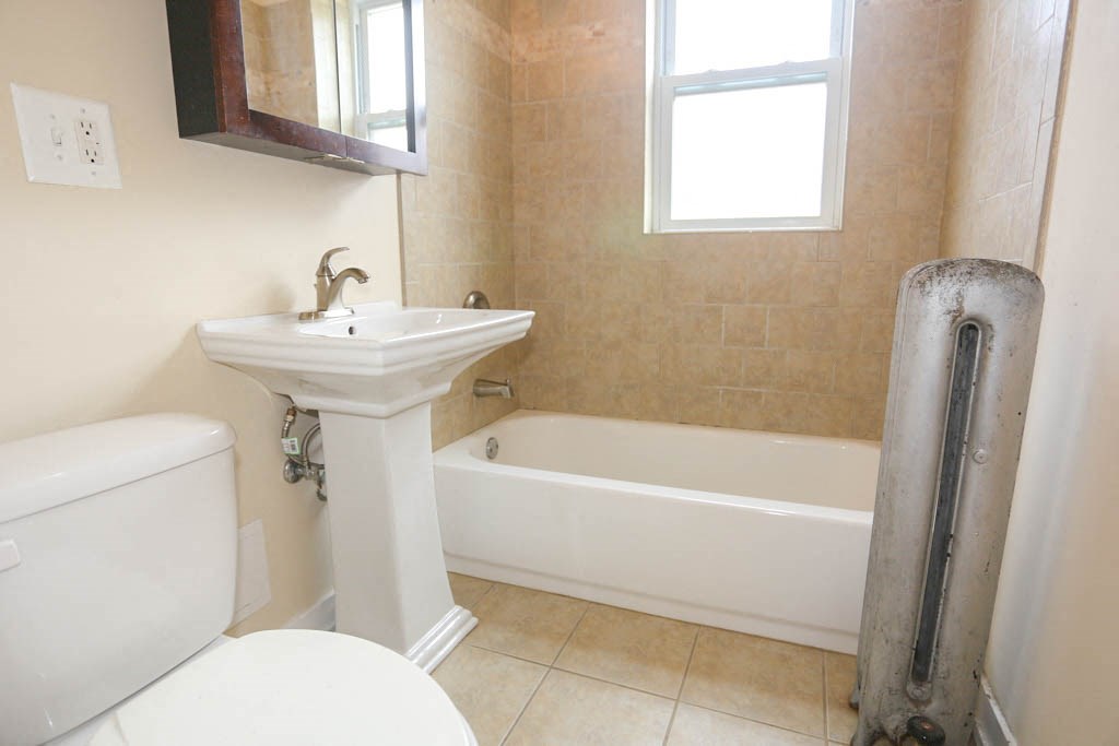 a bathroom with a sink toilet and a tub