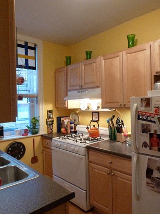 a kitchen with a stove and a refrigerator