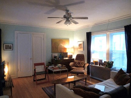 a living room with a ceiling fan and a