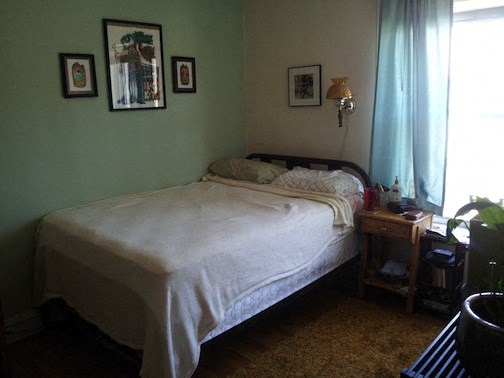 a bedroom with a bed and a table