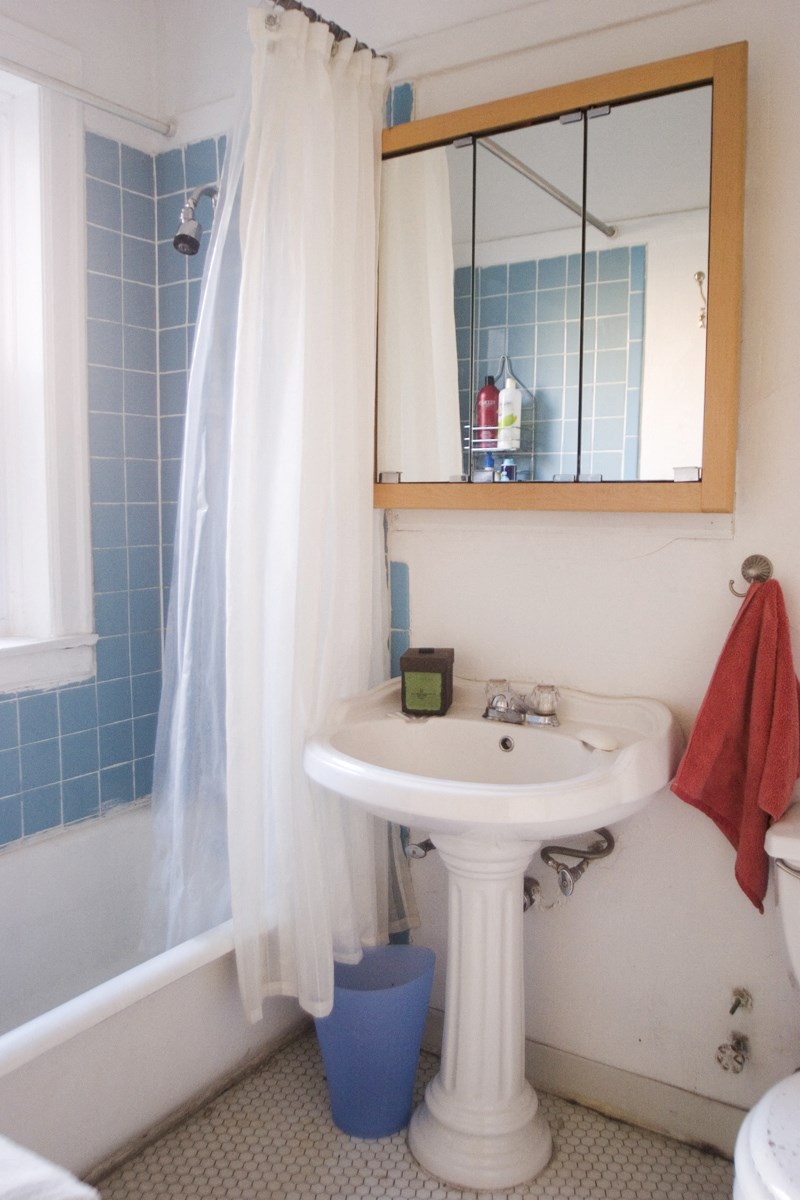 a bathroom with a sink and a mirror and a tub