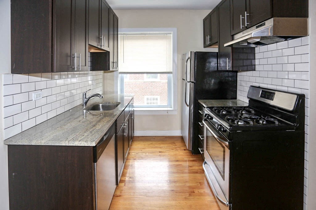a kitchen with a stove refrigerator and a sink
