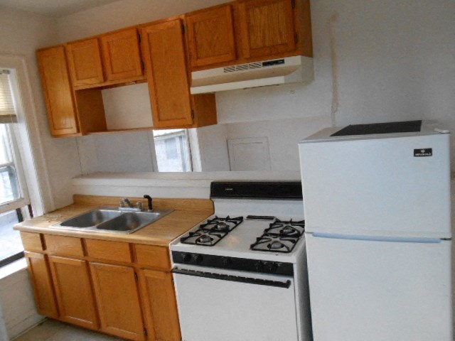 a kitchen with a stove and a refrigerator