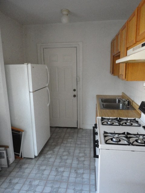 a kitchen with a stove and a refrigerator