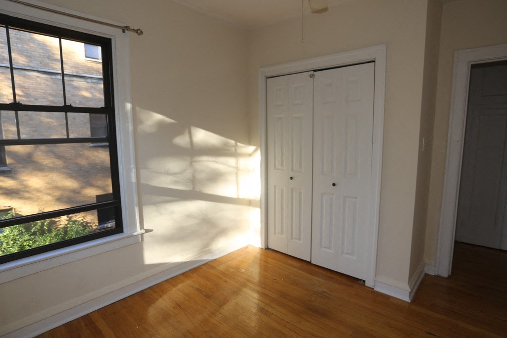 an empty room with a door and a window