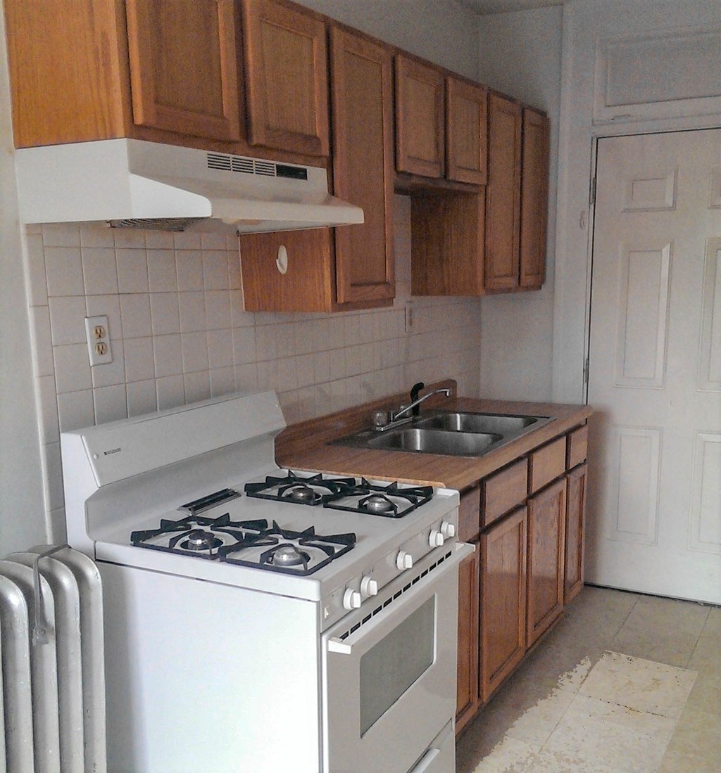 a kitchen with a stove and a sink