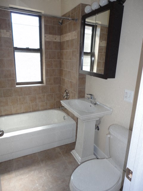 a bathroom with a sink toilet and a bath tub
