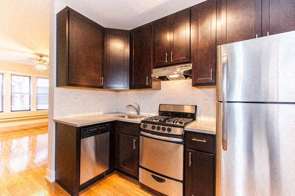 a kitchen with stainless steel appliances and wooden cabinets