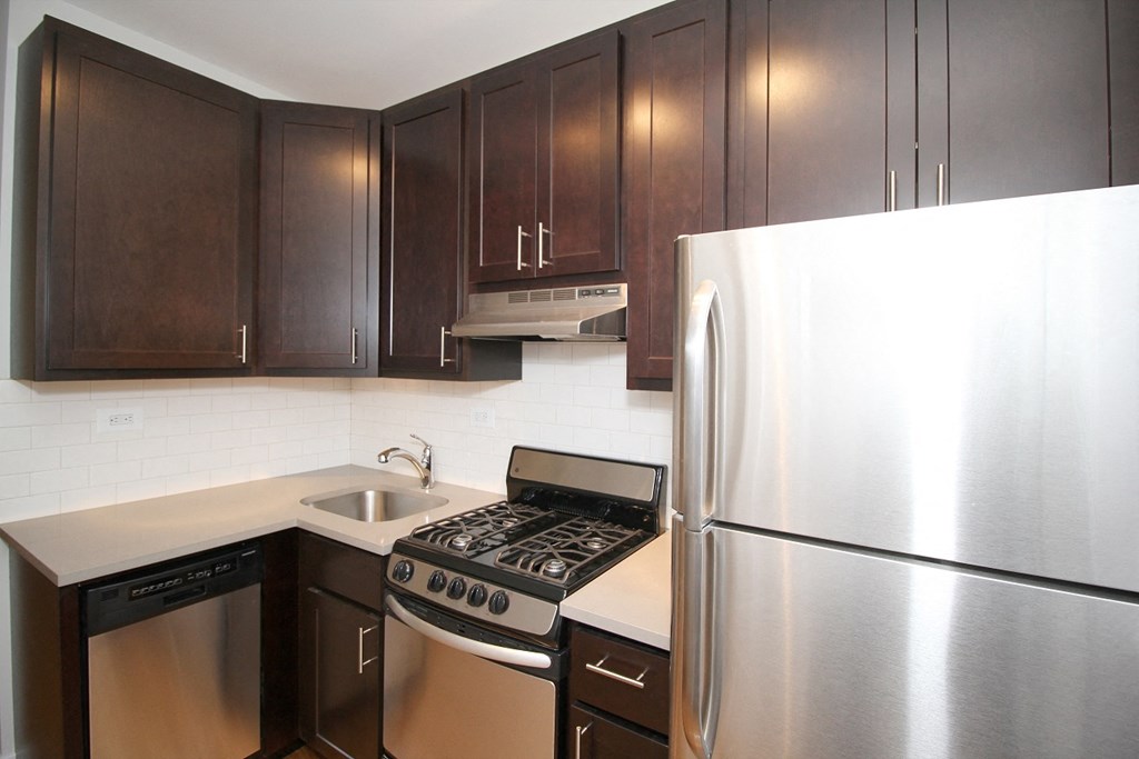 a kitchen with stainless steel appliances and wooden cabinets