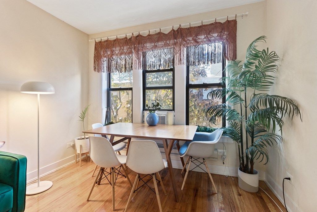 a dining room with a table and chairs and a window