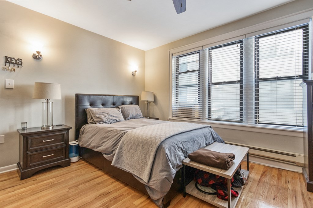 a bedroom with a bed and three windows