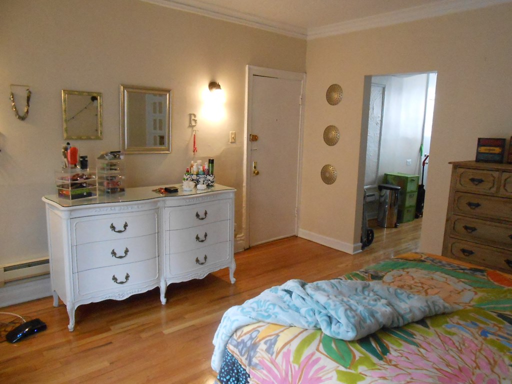 a bedroom with a bed and a dresser