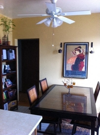 a dining room with a table and a ceiling fan