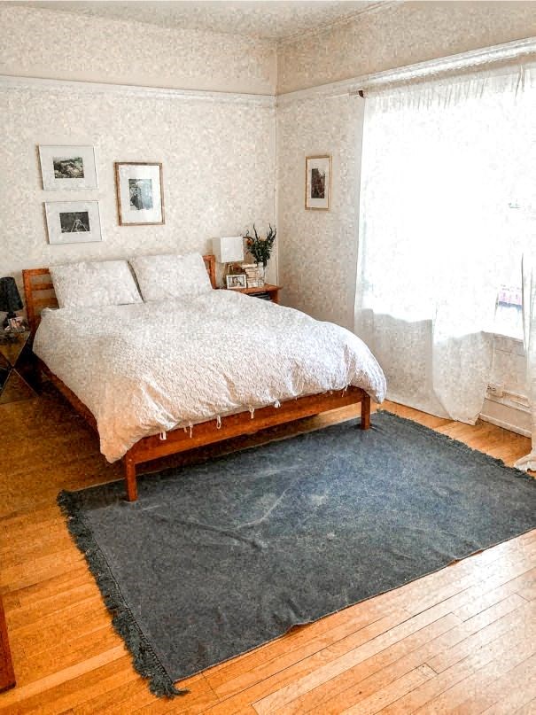 a bedroom with a bed and a rug