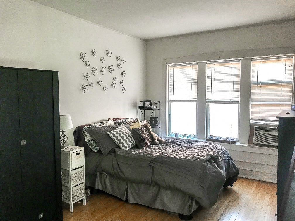 a bedroom with a bed and a window