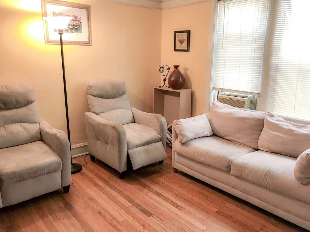a living room with a couch and two chairs