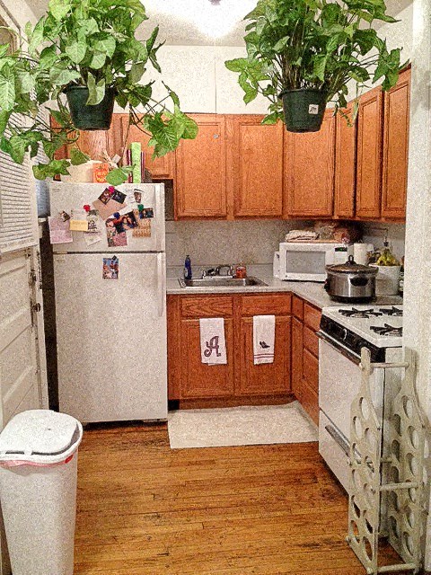 a kitchen with white appliances and wooden cabinets
