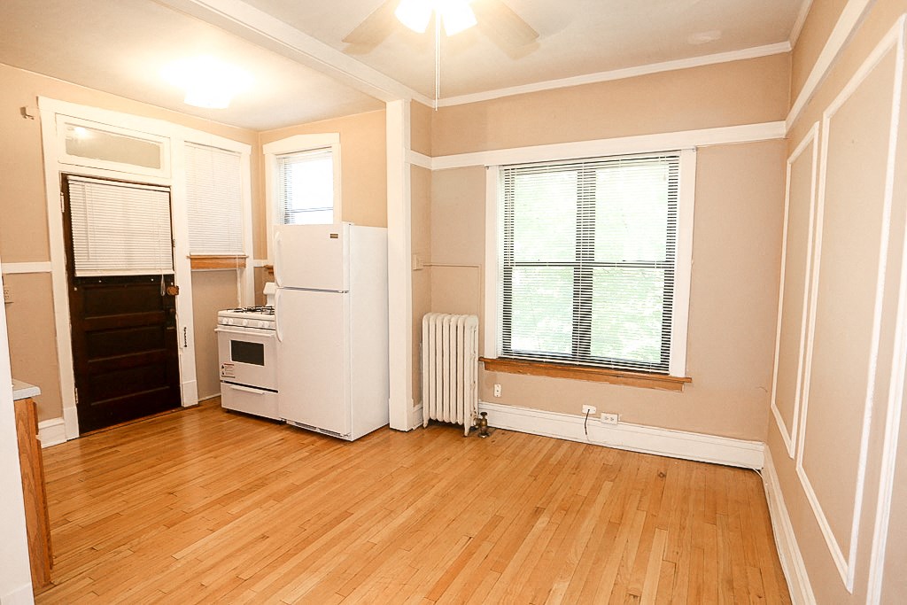 a kitchen with a stove and a refrigerator and a window