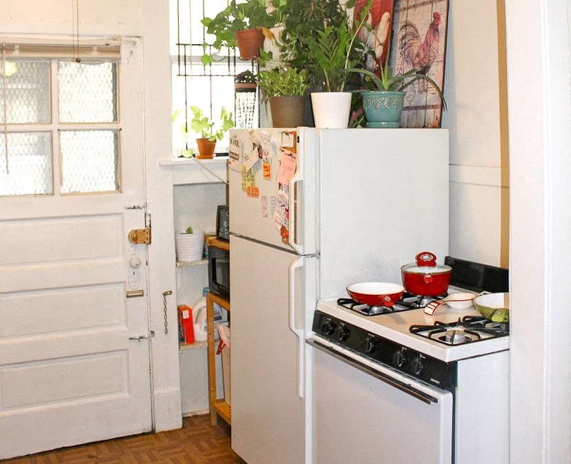 a small kitchen with a stove and a refrigerator