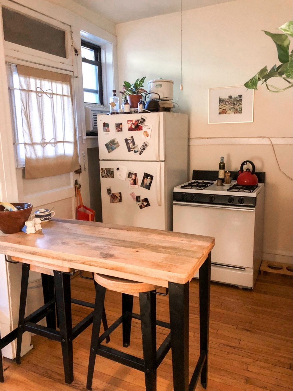 a kitchen with a wooden table and a refrigerator