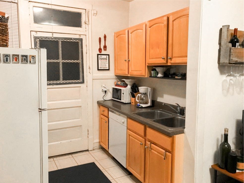 a kitchen with a sink and a refrigerator