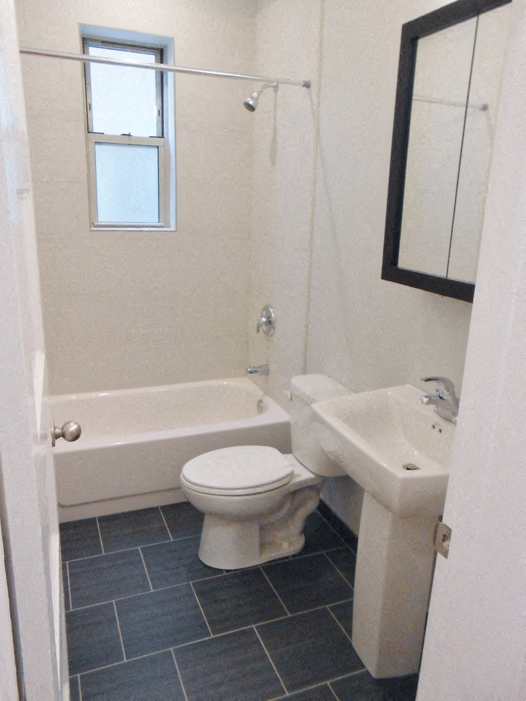 a bathroom with a toilet and a sink and a bath tub