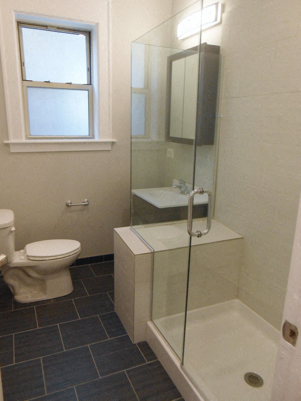 a bathroom with a toilet and a shower